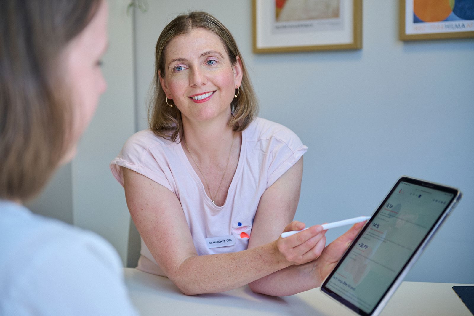 Physician explaining findings on the iPad